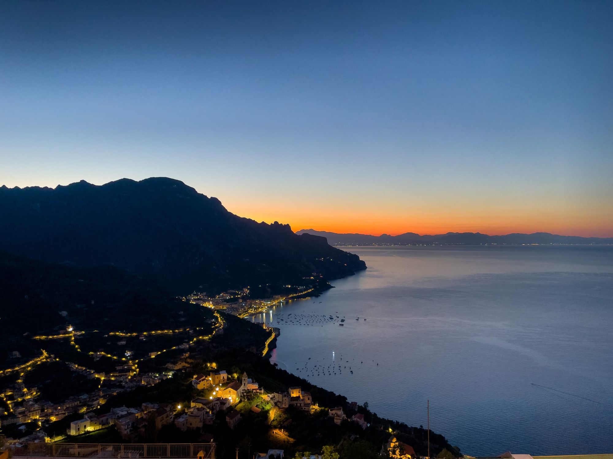 Orange and blue sky as sun rises over Gulf of Salerno